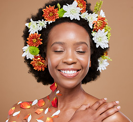 Image showing Hair flower, crown or beauty black woman with smile in brown studio background with glowing skin, facial skincare or wellness. Face, happy or wellness girl with flowers, rose or plants for spring