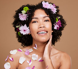 Image showing Flower, beauty and natural skincare health with organic plant cosmetic product for skin wellness, floral hair care and eco friendly spa treatment. Portrait of happy model, natural smile and afro hair