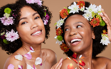 Image showing Women, beauty and flowers in studio for wellness, cosmetic and grooming on brown background. Flower, crown and black woman friends relax, hygiene and pamper, nature product and zen plant aesthetic