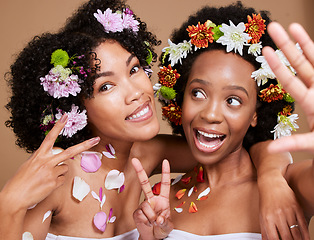 Image showing Beauty, friends and flowers with a model black woman pair in studio on a brown background for skincare. Nature, luxury and relax with an attractive young female and friend posing for natural wellness