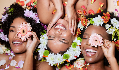 Image showing Top view, beauty and black women with flowers for skincare in studio on brown background. Makeup aesthetics, organic cosmetics and group, friends or female models with floral plants for healthy skin