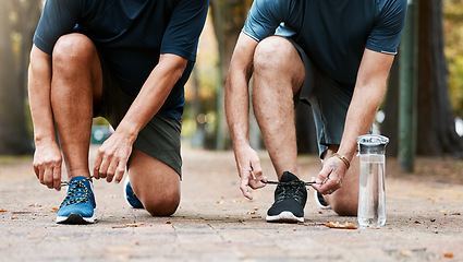 Image showing Fitness, run and men friends tying their shoes while doing an outdoor cardio workout in the city. Sports, footwear and male athletes running for exercise or training for marathon, race or competition