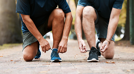 Image showing Legs, tie lace and sports running team for fitness or healthcare exercise outdoors. Healthy men, teamwork training workout and marathon wellness collaboration or check shoelace for run in nature park