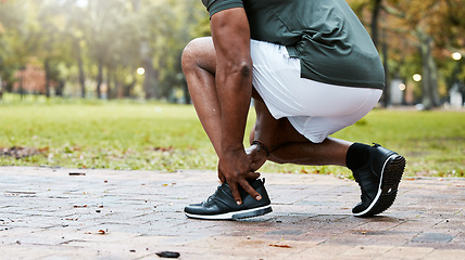 Image showing Sports, fitness runner or ankle pain on black man from exercise, training or wellness accident in park, street or nature. Zoom of male athlete health risk, muscle injury from workout while running.