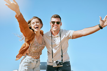 Image showing Happy, couple and travel with freedom, love and vacation adventure together having a fun. Portrait of happy couple in nature on holiday journey with free, relax and happiness feeling in summer sky