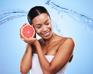 Image showing Water splash, grapefruit and skincare of a black woman holding fruit, diet food and nutrition. Vitamin c, cosmetic health and wellness of a model with water happy about zen beauty and healthy eating