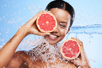 Image showing Grapefruit, black woman and water splash, vitamin c beauty and skincare wellness, healthy body and aesthetics, natural cosmetics and face on studio background. Portrait model, wet citrus and detox