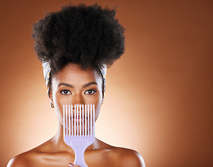 Image showing Black woman, hair care beauty or model with afro comb in brown studio background portrait. Health salon, wellness or African American girl and face with natural curly hair and mockup with brush