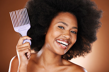 Image showing Happy black woman, hair care and comb in portrait with afro pick, beauty and self care by brown backdrop. African woman, model and cosmetics with makeup or happiness for combing by studio background