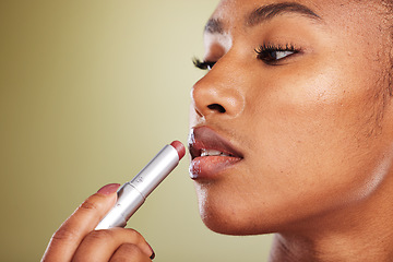 Image showing Lipstick, black woman and skincare for wellness, cosmetics, smooth lips or against brown studio background. Makeup, African American female or girl with lip balm, for gloss or soft for natural beauty