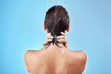Image showing Back, woman and shower for hygiene, bathroom and freshness on blue studio background. Mockup, female and healthy girl with water, clean and wet for wellness, skincare and health with drops and splash