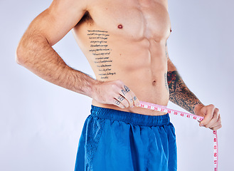 Image showing Measure tape, muscular and man check progress, health and wellness against grey studio background. Bodybuilder, healthy male and track diet, training and exercise after workout, body care and fitness