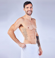 Image showing Man, fitness and towel portrait for strong bodybuilder athlete posing on a grey studio background. Athletic, shirtless and abs with a personal trainer and six pack for bodycare, skincare and hygiene