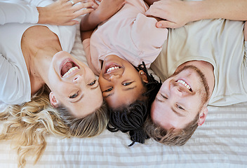 Image showing Family, children and adoption with a mother, father and daughter lying on a bed in their home together. Portrait, love and kids with a man, woman and girl bonding in a house bedroom from above