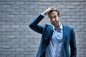 Image showing Fashion, mockup and suit with a business man or model standing outdoor in the city on a brick wall background. Portrait, style and mock up with a handsome male employee posing in an urban town