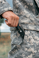 Image showing A man with a knife in the forest.