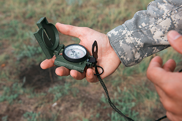 Image showing Man with compass in hand outdoor