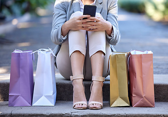 Image showing Shopping bag, city and woman on smartphone for e commerce, customer sale and online discount with zoom of shoes or feet. Retail, cellphone and urban street of customer with online shopping app luxury