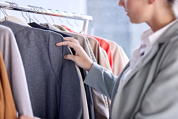 Image showing Shopping, fashion and retail, woman looking at clothes in designer boutique in mall. Happy customer with budget and choice, luxury clothing on rail and a discount sale at the expensive shopping mall.