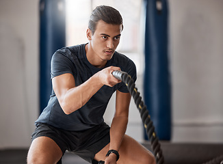 Image showing Fitness, man and rope exercise, sports training and workout for muscle, energy and wellness in gym. Focus bodybuilder guy moving battle ropes with energy, action and power, challenge and healthy body