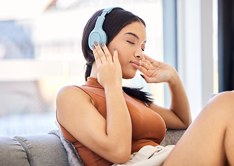 Image showing Headphones, music and woman on sofa listening to podcast streaming service with student discount subscription for mental health wellness. Relax, calm and peace of young gen z girl on audio sound tech