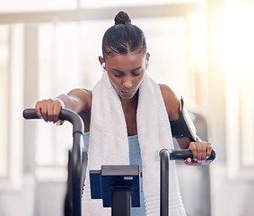 Image showing Stationary, bike and fitness black woman in gym for exercise challenge, workout motivation and goal with speed, fast and heart algorithm technology. Cycling machine, sports and Crossfit training girl