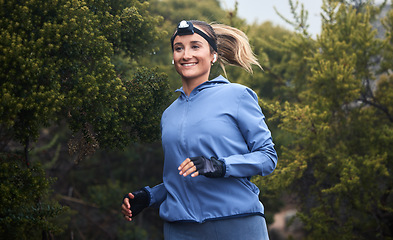 Image showing Fitness, nature and woman running on a trail for cardio workout in the woods or green garden. Health, wellness and young woman from Canada training for sports marathon, race or competition in forest.