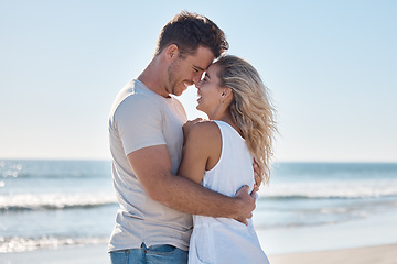 Image showing Couple, love and hug in relationship at the beach for summer vacation or romantic bonding in the outdoors. Happy man and woman hugging with smile together in loving embrace for romance by the ocean