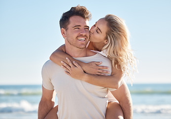 Image showing Beach love, hug and couple kiss on romantic date, bonding getaway or outdoor nature adventure for peace, freedom and fun. Ocean sea, blue sky and man and woman piggyback on Sydney Australia holiday