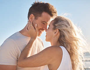 Image showing Love, couple and beach holiday, vacation or summer date and honeymoon outdoors. Affection, romance and smile of man and woman ready for kiss, having fun and enjoying quality time together at seashore