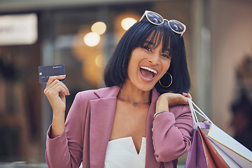 Image showing Shopping, credit card and happy woman, portrait and mall, money and finance for luxury promotion, retail payment and discount in store, market and boutique. Rich customer, account and shopping mall