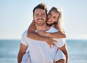 Image showing Happy couple, beach and portrait of happiness with a piggy back game for fun, happiness and energy on vacation in summer. Man and woman feeling love, care and happy in a healthy marriage outdoor