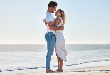 Image showing Hug, beach and happy couple on a romantic vacation for love together by the ocean in Australia. Travel, romance and young man and woman embracing while on a seaside honeymoon holiday or adventure.