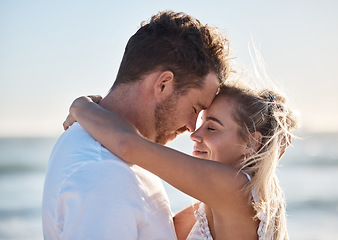 Image showing Couple, love and hug on beach eyes closed, smile and happy for relax travel vacation or quality time together. Happiness, man and woman hugging for romance marriage, honeymoon or holiday in sunshine