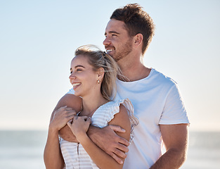 Image showing Happy couple, love and beach vacation in summer with a hug, care and support while thinking about future and marriage. Man and woman outdoor by the ocean for fresh air, travel and holiday in nature