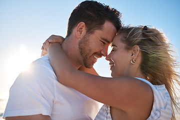 Image showing Couple, forehead and hug for love, care or support in relationship romance and bonding together in the outdoors. Happy man and woman hugging in loving embrace or compassion for summer vacation travel