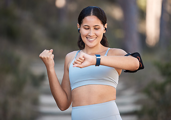 Image showing Fitness, exercise and woman celebrate goal with watch to check pulse, performance and time while in forest or nature for cardio workout and running. Female outdoor for training with smartwatch
