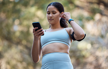 Image showing Fitness, earphones and woman with phone in nature for running music, radio or podcast outdoors. Health, wellness and female with 5g mobile smartphone streaming audio, song or sound on training break.