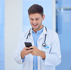 Image showing Doctor, man and phone with smile for texting, communication or chatting and good connection at hospital. Happy male healthcare or medical professional smiling for telecommunication service at clinic