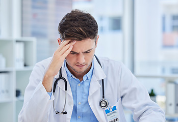 Image showing Headache, stress and doctor working in his office doing medical research or analyzing test results. Burnout, exhausted and frustrated healthcare worker in a consultation room writing hospital report.