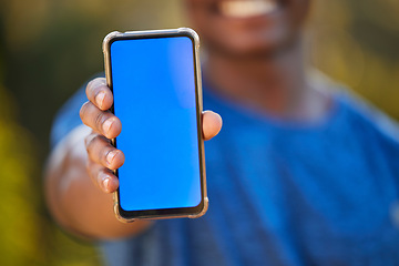 Image showing Phone, mockup and blue screen in the hand of a black man outdoor for exercise or fitness tracking. Marketing, advertising and green screen with a male athlete holding mobile display to show an app
