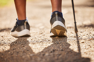 Image showing Hike, foot and walking stick with a person hiking for fitness, health and wellness on a path in nature. Adventure, exercise and freedom with a healthy hiker on the mountain in the wilderness