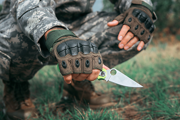 Image showing A man with a knife in the forest.