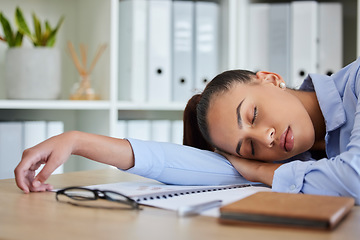 Image showing Tired, sleep and woman in business on her table feeling burnout and overworked while sleeping in her office. Nap, dreaming and exhausted with fatigue businesswoman napping on her table at work