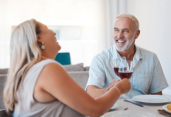 Image showing Couple, wine and senior man and woman toast in anniversay celebration with a delicious meal in the family home. Red wine, love and husband and wife cheers for loving romantic relationship