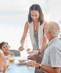 Image showing Family, lunch and woman serve food to father in the family home at the dining table for nutrition, diet and wellness. Meal, mother and daughter eating meal with grandfather at home for bonding