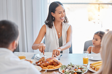 Image showing Chicken, happy and family lunch with woman cutting with knife, meal and food in dining room or celebration event. Love, happiness and group of people eating or laugh at brunch in family home together