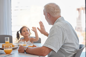 Image showing High five, breakfast and family with a girl and grandfather sitting at a dining room table for eating food. Motivation, health and children with a senior man encouraging his grandchild to eat healthy