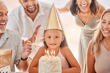 Image showing Birthday, candles on birthday cake and child with big family celebrate party event, sing together and show girl love in apartment home. Happy mother, father and child bonding with grandparents smile