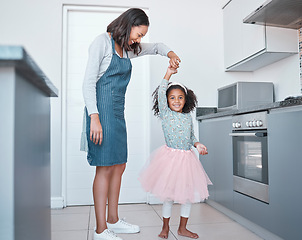 Image showing Mother, child and dancing in home kitchen for love, energy and fun together as a family with happiness, care and support. Black woman and girl or daughter with princess tutu to dance while cooking